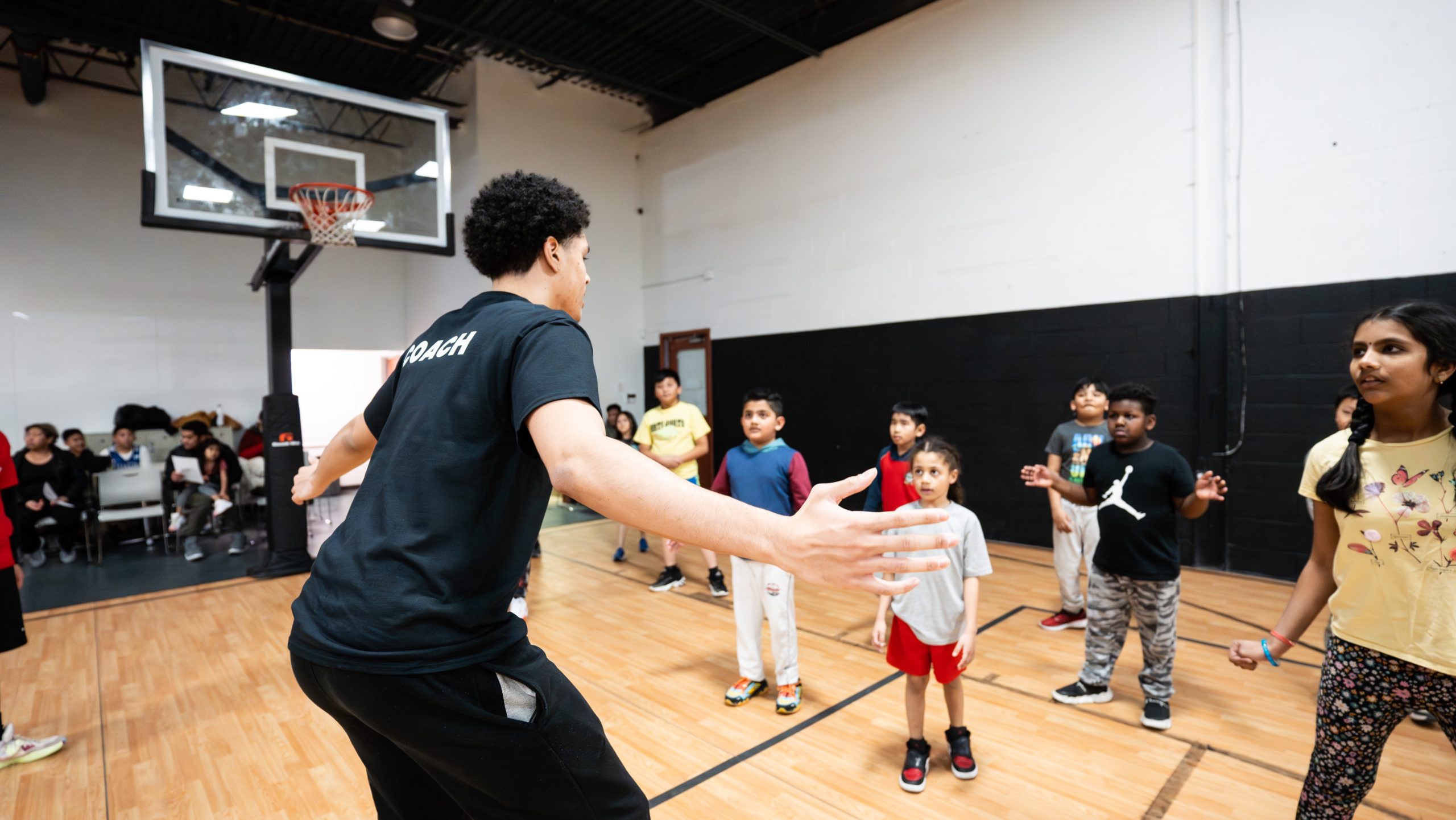 Coach instructing kids
